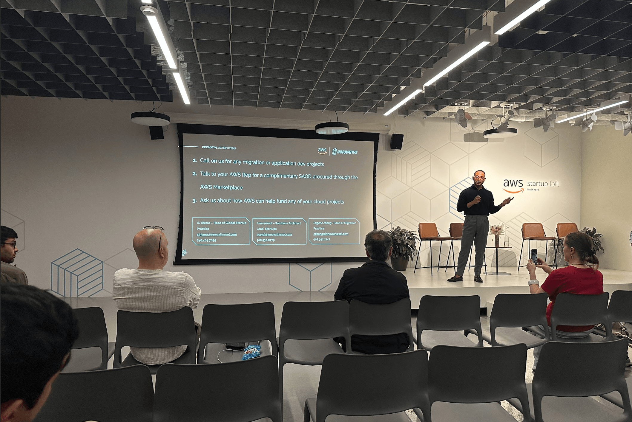 A speaker presenting to a seated audience at a cloud technology event
